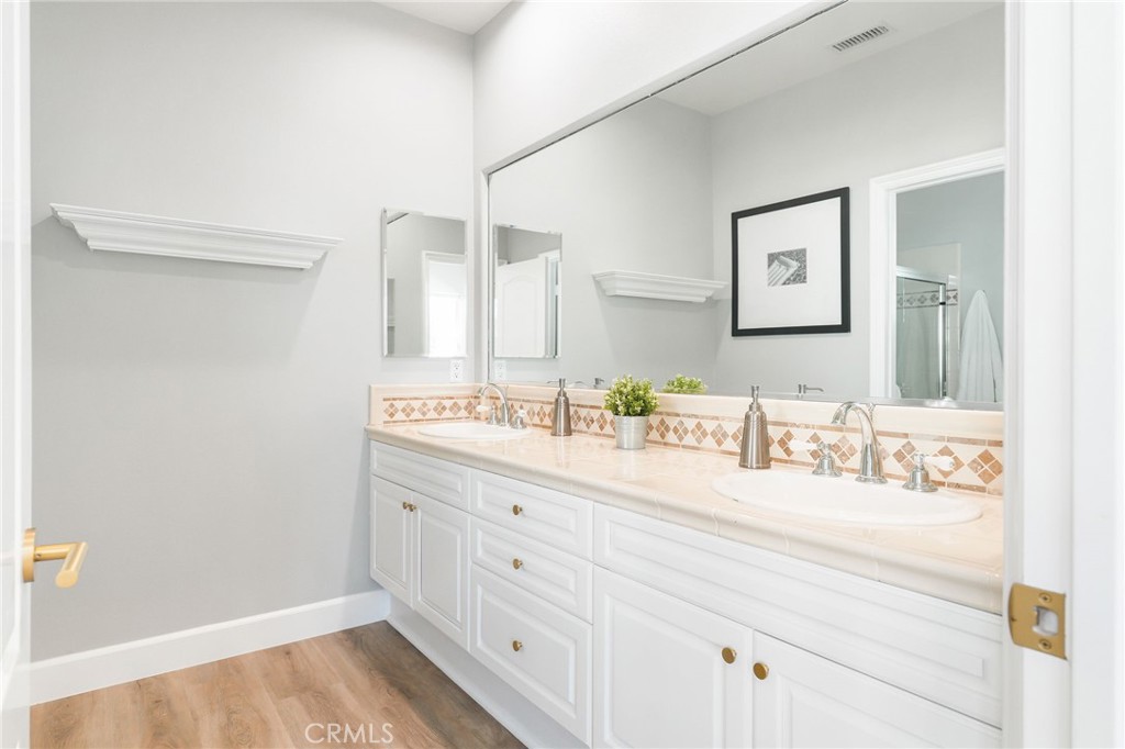 20112 Vía Cellini Porter Ranch, CA 91326 - Photo 41 of 64 a bathroom with a sink and a mirror