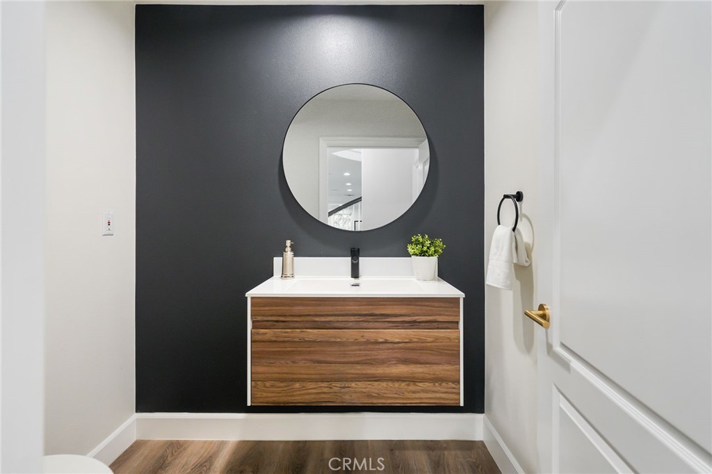 20112 Vía Cellini Porter Ranch, CA 91326 - Photo 49 of 64 a bathroom with a sink a mirror and a light fixture
