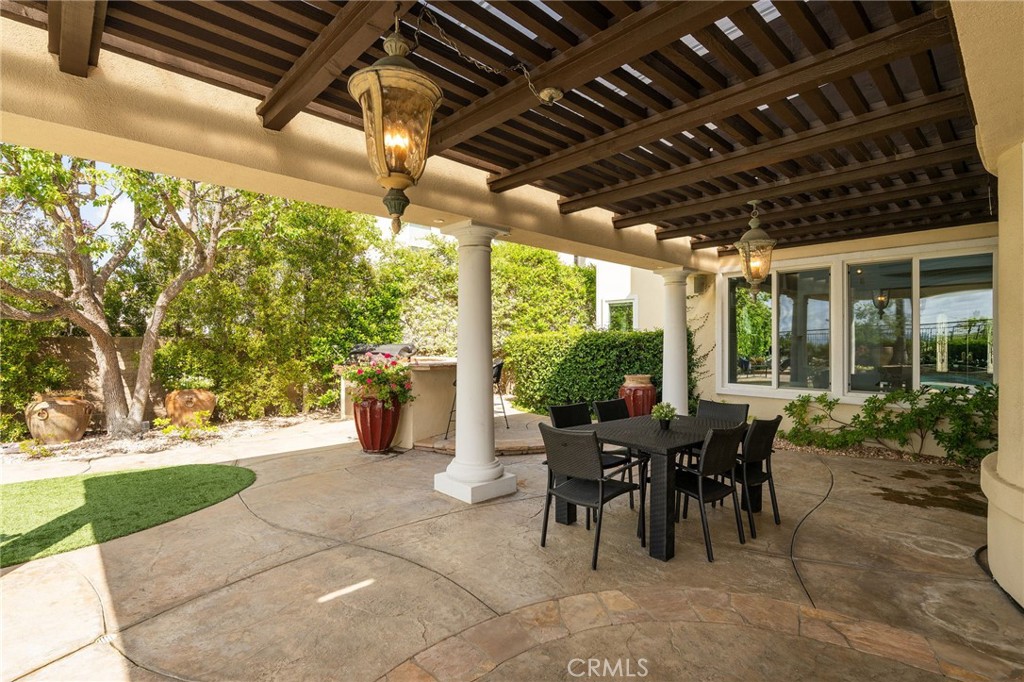 20112 Vía Cellini Porter Ranch, CA 91326 - Photo 61 of 64 a view of a porch with dining table and chairs