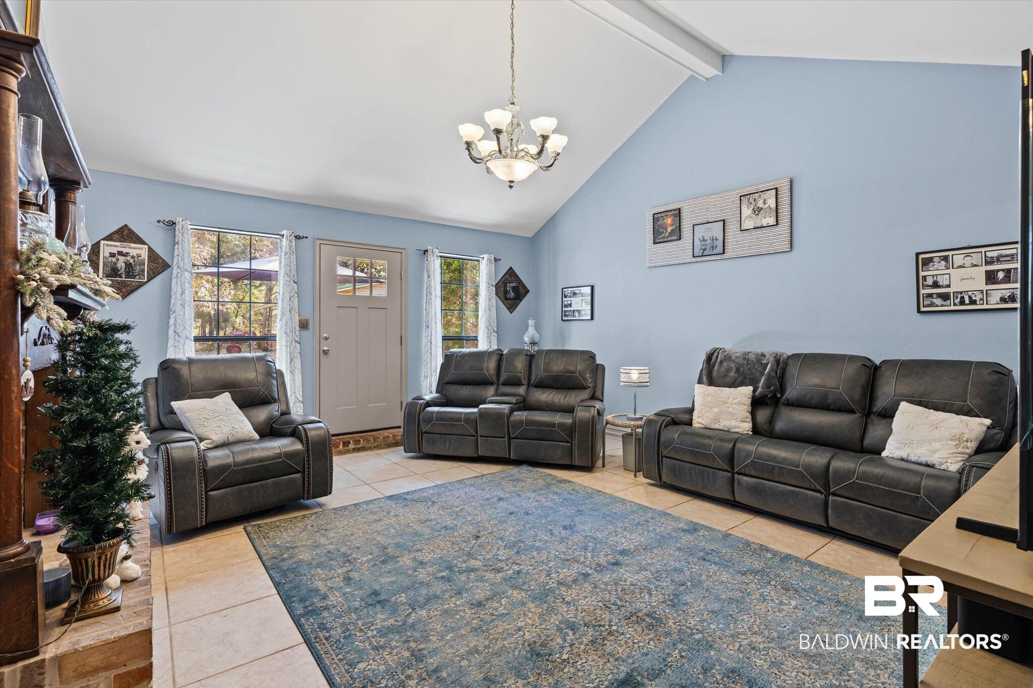 3846 Leslie Road Saraland, AL 36571 - Photo 6 of 40 Living area featuring light tile patterned floors, beam ceiling, high vaulted ceiling, and a chandelier