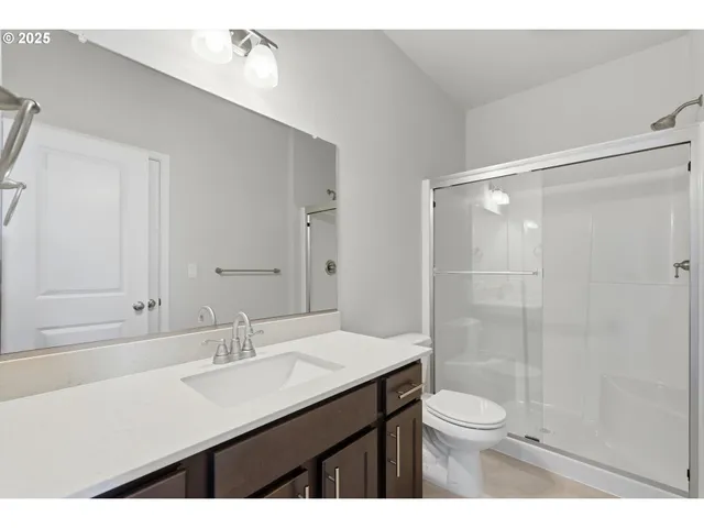 a bathroom with a sink double vanity and a mirror