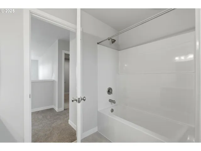 a spacious bathroom with a double vanity sink and a mirror