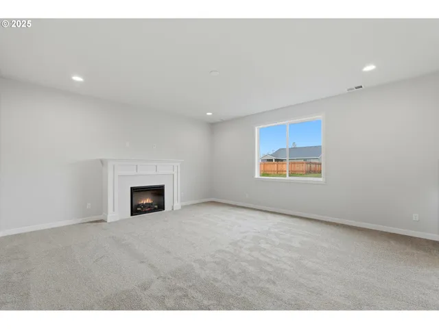a view of an empty room with a fireplace