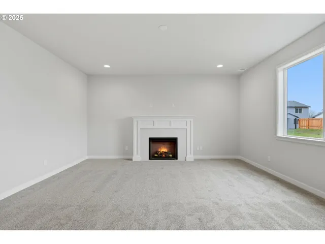 a view of a livingroom with a fireplace and window