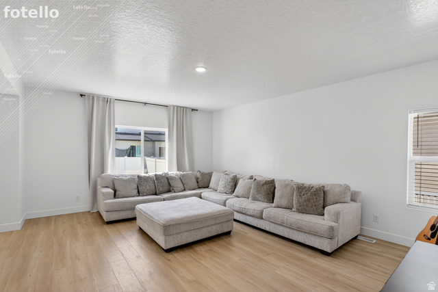 815 West Powderwood Lane Mapleton, UT 84664 - Photo 8 of 39 Living room with light wood finished floors and a textured ceiling