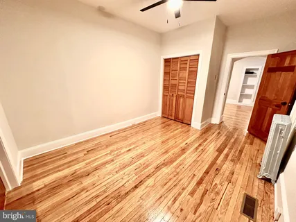 a view of a room with wooden floor and bathroom