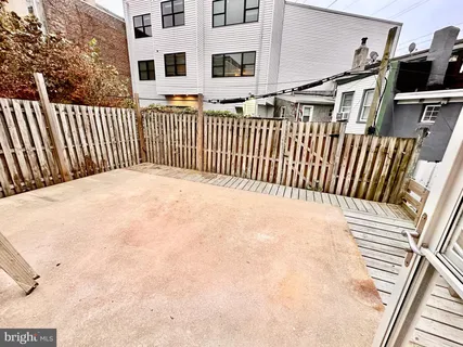 a view of a house with a wooden deck
