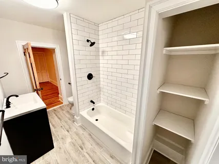 a bathroom with a bathtub and a sink