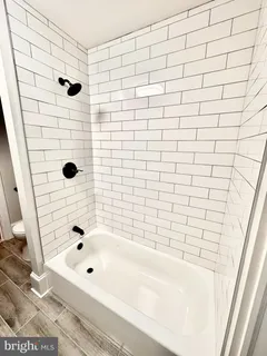 a bathroom with a bathtub and shower