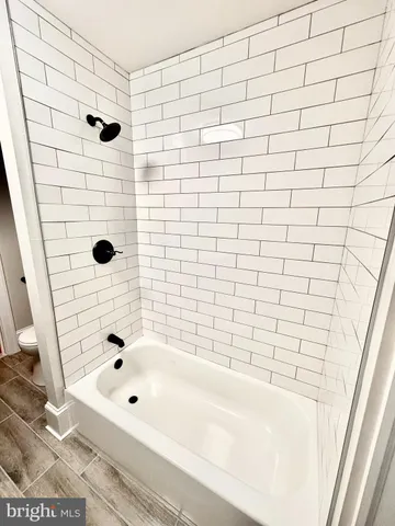 a bathroom with a bathtub and shower