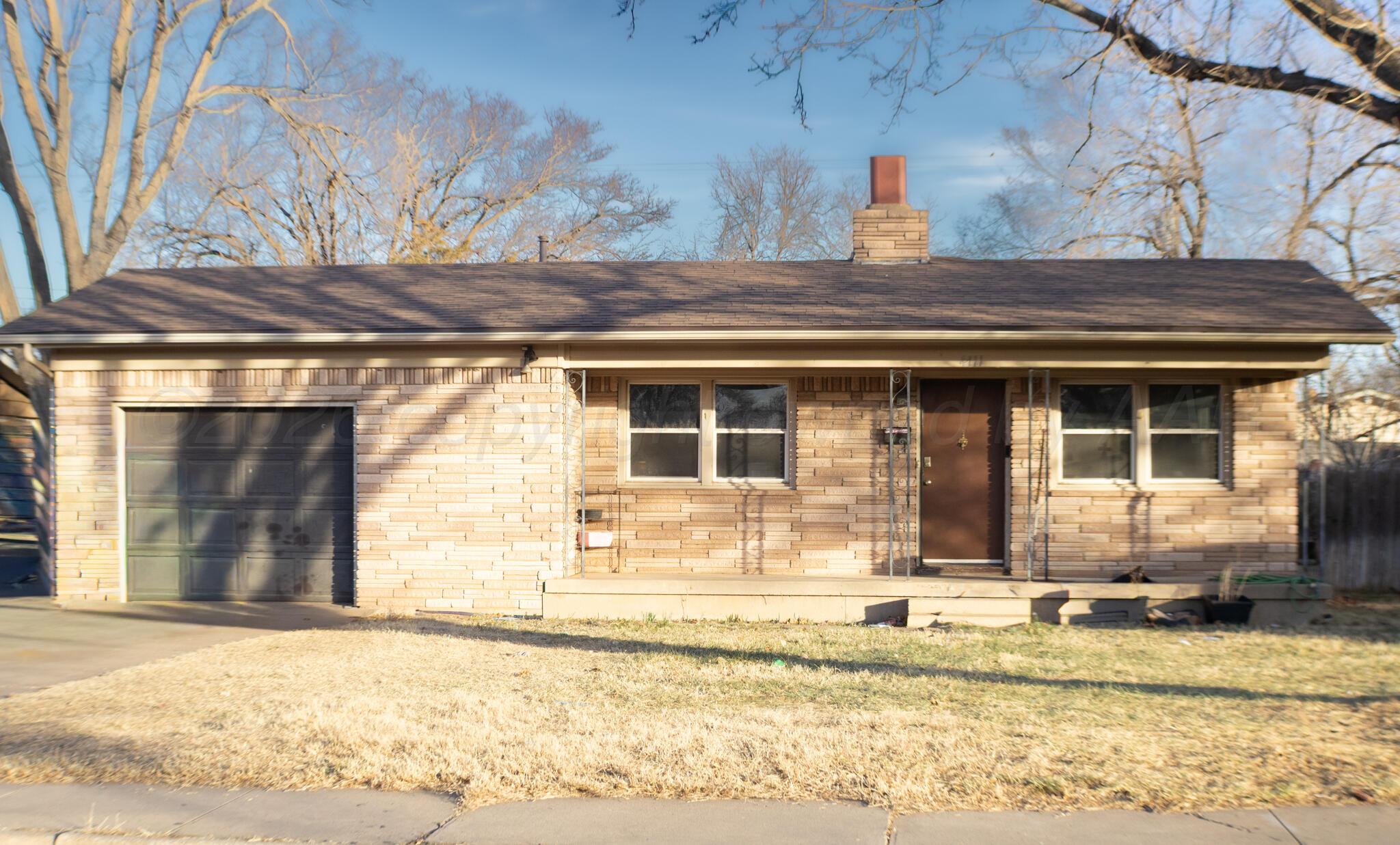 4711 South Rusk Street Amarillo, TX 79110 - Photo 1 of 24 a front view of a house with a yard