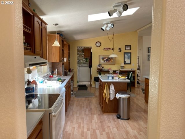 95685 Martin Ranch Road Brookings, OR 97415 - Photo 9 of 17 a room with stainless steel appliances kitchen island granite countertop lots of clutter and cabinets