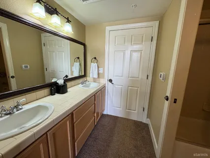 a bathroom with a sink a vanity and a mirror