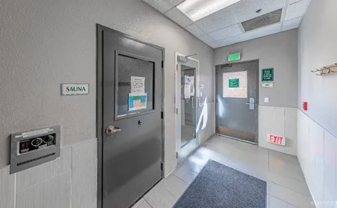 a view of a hallway to rooms and stairs