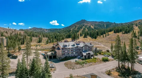 a view of a swimming pool with a patio and a yard