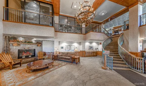 a view of a large building with mountains in the background