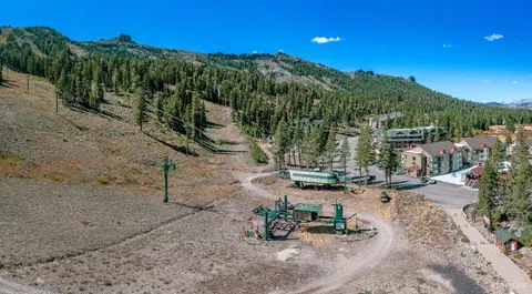 an aerial view of a house with yard