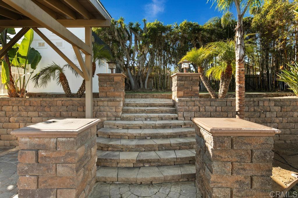 5199 El Arbol Drive Carlsbad, CA 92008 - Photo 12 of 57 LEADING UP TO YET ANOTHER GRASSY LAWN AND SHEDS