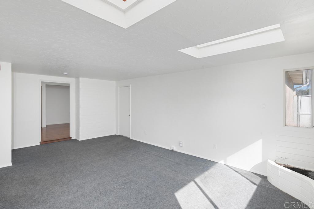 5199 El Arbol Drive Carlsbad, CA 92008 - Photo 28 of 57 Bonus room of living room/garage, 2 skylights and south facing windows. Gym, play room, office?