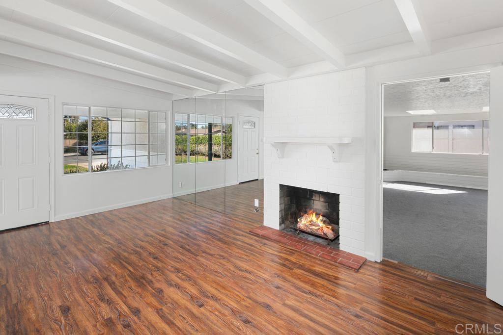 5199 El Arbol Drive Carlsbad, CA 92008 - Photo 6 of 57 Living room with fireplace and bonus room access.