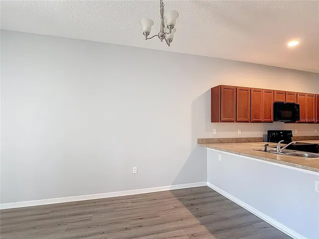 a view of kitchen with wooden floor and cabinet