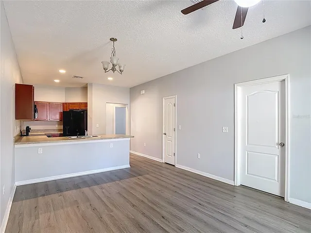 a view of kitchen with wooden floor and electronic appliances