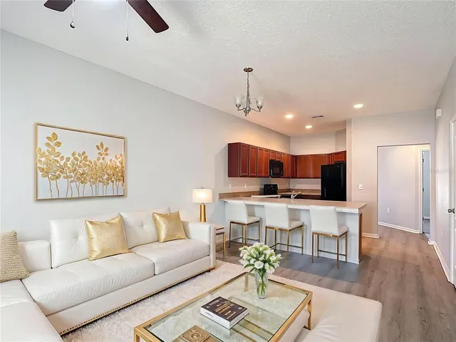 a living room with furniture and kitchen view