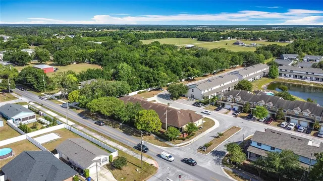 an aerial view of a city with lots of residential buildings and mountain view in back