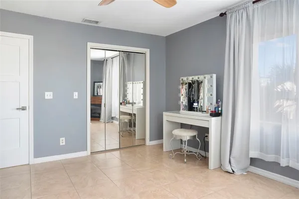 an empty room with windows and cabinet