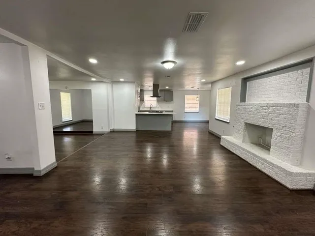 a view of a kitchen with a sink and a stove top oven