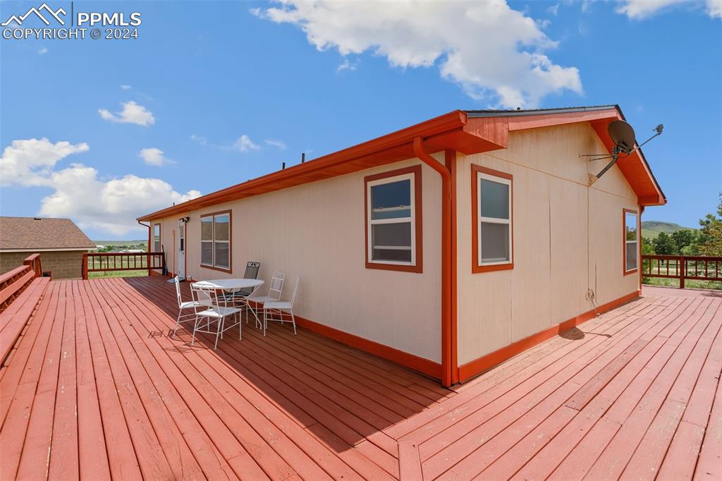 12155 South Mesa View Road Larkspur, CO 80118 - Photo 13 of 16 a view of a house with wooden floor