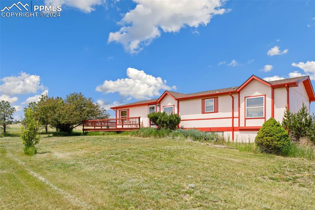 12155 South Mesa View Road Larkspur, CO 80118 - Photo 8 of 16 a view of a house with a yard