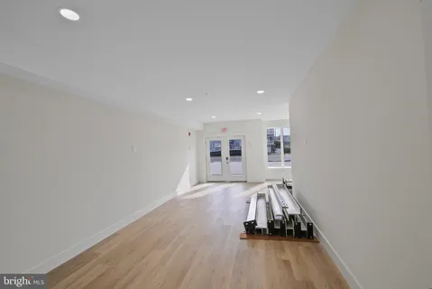 a view of a room with wooden floor and a sink