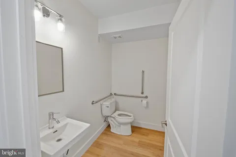 a bathroom with a sink and mirror with toilet