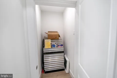 a view of a hallway with a white cabinet