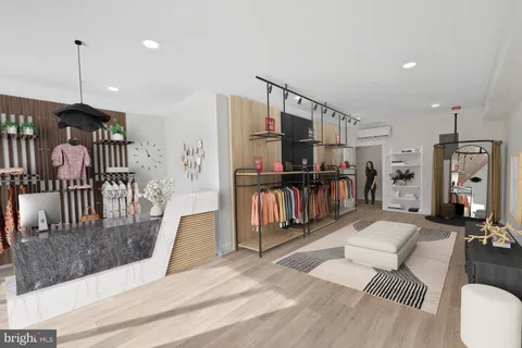 a living room with lots of furniture and kitchen view