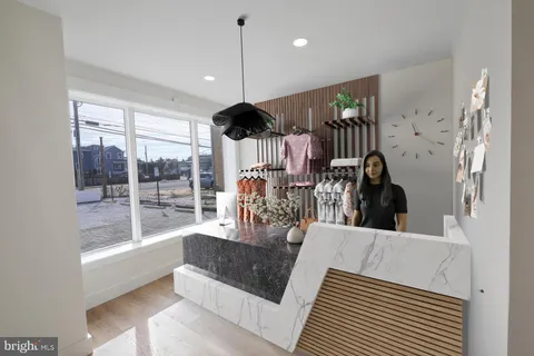 a view of a living room and kitchen floor to ceiling window