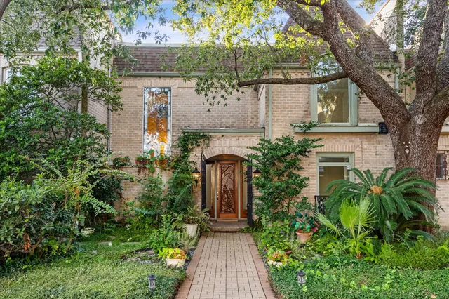 an entrance to house with yard and green space