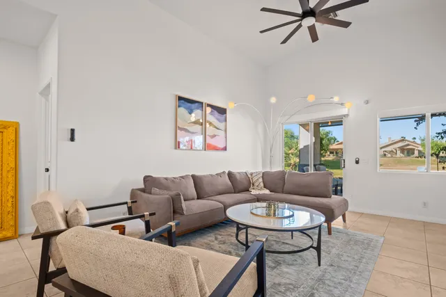 a large kitchen with granite countertop a sink stainless steel appliances and cabinets