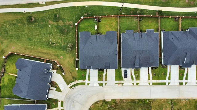 an aerial view of a house with a garden and outdoor seating