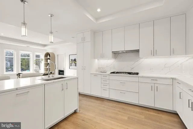 a kitchen with granite countertop a stove and a refrigerator
