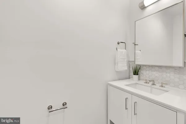 a living room with furniture a table and a potted plant