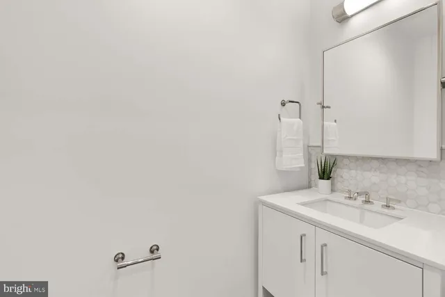 a living room with furniture a table and a potted plant