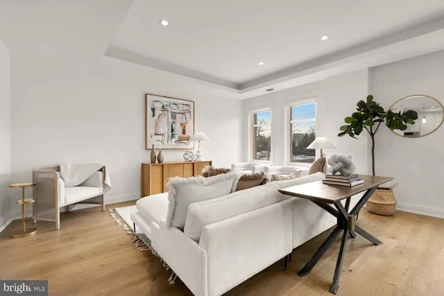 a living room with furniture a chandelier and a table