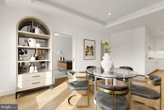 a living room with furniture a rug and a lamp