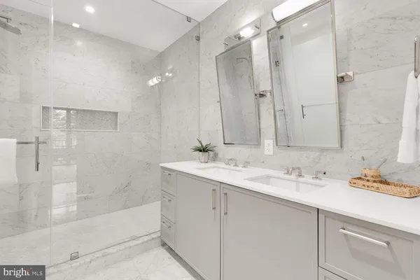 a spacious bedroom with a bed and a dresser