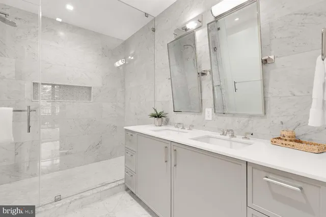 a spacious bedroom with a bed and a dresser