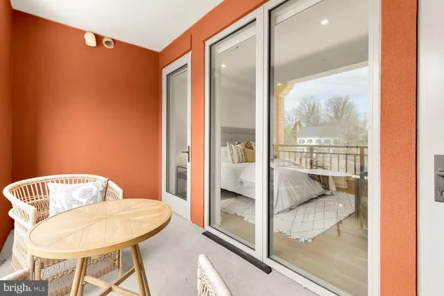 a bedroom with a bed and painting on the wall