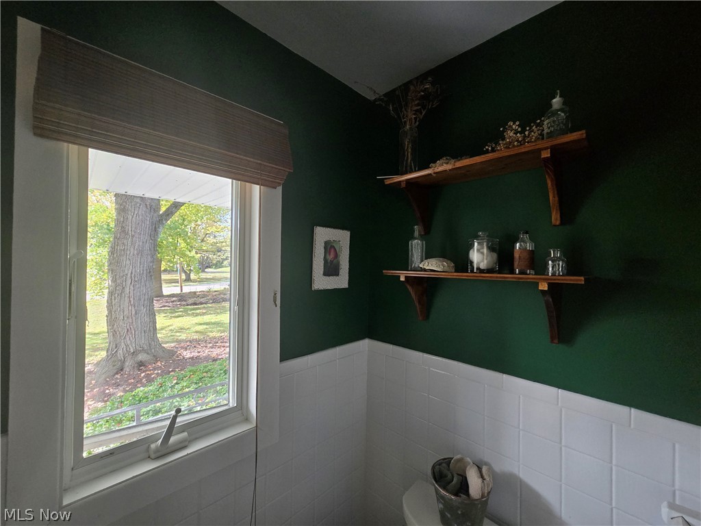 4639 Brainard Road Chagrin Falls, OH 44022 - Photo 36 of 50 Another view of half bathroom showing walls, tile, and window.