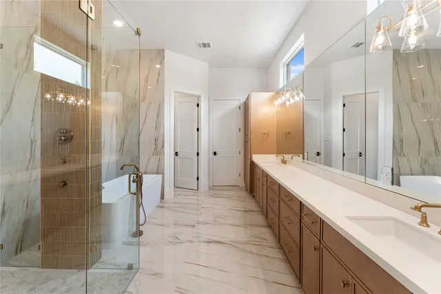 a large bathroom with a double vanity sink a large mirror and shower